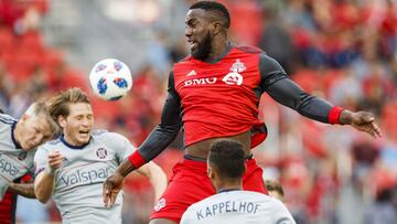 FILE - In this July 28, 2018, file photo, Toronto FC's Jozy Altidore leaps for the ball between Chicago Fire players, including Johan Kappelhof (4), during the first half of an MLS soccer match, in Toronto. Toronto FC confirmed Thursday, Feb. 28, 2019, that star striker Jozy Altidore is staying put. The 29-year-old U.S. international has signed a three-year contract extension that will keep him in Toronto through the 2022 season.(Mark Blinch/The Canadian Press via AP, File)