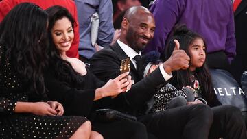 Dec 18, 2017; Los Angeles, CA, USA; Former Laker player Kobe Bryant (C) gives the thumbs up to fans prior to the Los Angeles Lakers game against the Golden State Warriors at Staples Center. Bryant is having his two uniform numbers, 8 and 24, retired during a halftime ceremony. Mandatory Credit: Robert Hanashiro-USA TODAY Sports     TPX IMAGES OF THE DAY