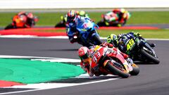 NORTHAMPTON, ENGLAND - AUGUST 25: Marc Marquez of Spain and Repsol Honda leads Valentino Rossi of Italy and Monster Energy Yamaha MotoGP and Alex Rins of Spain and Team Suzuki Ecstar at the front of the field on the first lap during the MotoGP of Great Br