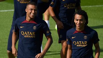 Paris Saint-Germain's French forward Kylian Mbappe (L) and his younger brother Paris Saint-Germain's French Midfielder Ethan Mbappe react as they take part in a training session at the new "campus" of French L1 Paris Saint-Germain (PSG) football club at Poissy, some 30kms west of Paris on July 20, 2023, ahead of the club's Japan tour. (Photo by JULIEN DE ROSA / AFP)