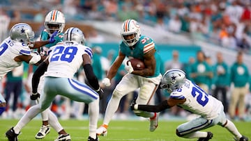 MIAMI GARDENS, FLORIDA - DECEMBER 24: Raheem Mostert #31 of the Miami Dolphins is tackled by DaRon Bland #26 of the Dallas Cowboys during the first half at Hard Rock Stadium on December 24, 2023 in Miami Gardens, Florida.   Megan Briggs/Getty Images/AFP (Photo by Megan Briggs / GETTY IMAGES NORTH AMERICA / Getty Images via AFP)