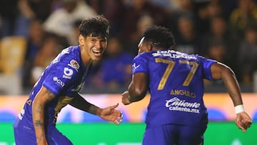 Pumas' Paraguayan forward #31 Robert Morales (L) celebrates after scoring the opening goal with teammate Pumas' Colombian defender #77 Alvaro Angulo during the Liga MX Clausura tournament football match between Tigres and Pumas at the University Stadium (UANL) in San Nicolas de los Garza, Mexico on January 14, 2026. (Photo by Julio Cesar AGUILAR / AFP)