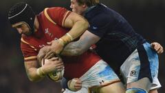 Wales&#039; lock Luke Charteris (L) is tackled during the Six Nations international rugby union match between Wales and Scotland at the Principality Stadium in Cardiff, south Wales, on February 13, 2016.