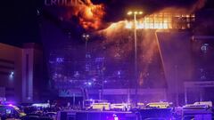 Ambulances and vehicles of Russian emergency services are parked outside the burning Crocus City Hall concert venue following a shooting incident, outside Moscow, Russia, March 22, 2024. REUTERS/Yulia Morozova