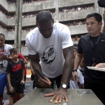 LeBron James deja la huella y la firma en una losa conmemorativa.