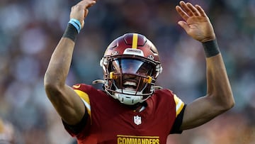 LANDOVER, MARYLAND - DECEMBER 22: Jayden Daniels #5 of the Washington Commanders celebrates his touchdown pass against the Philadelphia Eagles during the fourth quarter at Northwest Stadium on December 22, 2024 in Landover, Maryland. Timothy Nwachukwu/Getty Images/AFP (Photo by Timothy Nwachukwu / GETTY IMAGES NORTH AMERICA / Getty Images via AFP)