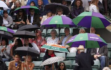 Wimbledon spectators wait during a rain delay on court 1.