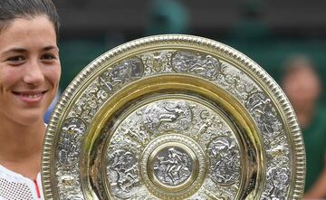 Spain's Garbine Muguruza holds up The Venus Rosewater Dish as she celebrates beating US player Venus Williams to win the women's singles final on the twelfth day of the 2017 Wimbledon Championships at The All England Lawn Tennis Club in Wimbledon, southwe