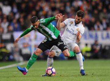 MADRID, SPAIN - MARCH 12:  Antonio Sanabria of Real Betis Balompie tackles Nacho of Real Madrid during the La Liga match between Real Madrid CF and Real Betis Balompie at Estadio Santiago Bernabeu on March 12, 2017 in Madrid, Spain.  (Photo by Denis Doyle