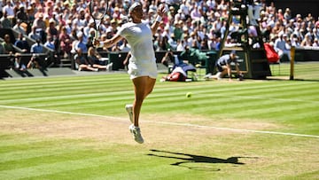 Tunisia's Ons Jabeur jumps as she plays against 's Tatjana Maria during their women's singles semi final tennis match on the eleventh day of the 2022 Wimbledon Championships at The All England Tennis Club in Wimbledon, southwest London, on July 7, 2022. (Photo by Glyn KIRK / AFP) / RESTRICTED TO EDITORIAL USE
