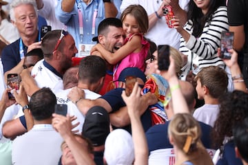Novak Djokovic celebrates with his family after winning the gold medal.