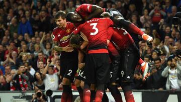 Manchester United's English defender Luke Shaw celebrates with teammates after scoring the team's second goal during the English Premier League football match between Manchester United and Leicester City at Old Trafford in Manchester, north west
