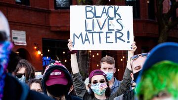 CHICAGO, ILLINOIS - JUNE 14: A protester holds a sign during a march in support of Black Lives Matter and Black Trans Lives in Boystown on June 14, 2020 in Chicago, Illinois. Protests erupted across the nation after George Floyd died in police custody in 