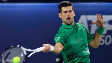 Novak Djokovic of Serbia returns the ball to Lorenzo Musetti of Italy during their ATP Dubai Duty Free Tennis Championship round of 32 match in the Gulf emirate of Dubai on February 21, 2022. (Photo by Karim SAHIB / AFP)