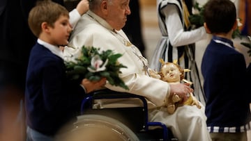Pope Francis holds a figure of baby Jesus during celebration of Christmas Eve mass in St. Peter's Basilica at the Vatican, December 24, 2023. REUTERS/Remo Casilli
