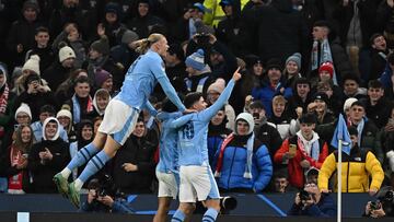 Manchester City's Argentinian striker #19 Julian Alvarez (R) celebrates scoring the team's third goal during the UEFA Champions League Group G football match between Manchester City and RG Leipzig at the Etihad Stadium, in Manchester, north west England, on November 28, 2023. (Photo by Paul ELLIS / AFP)