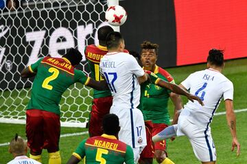 Cameroon's defender Adolphe Teikeu (back C) and Cameroon's defender Ernest Mabouka (L) challenge Chile's defender Gary Medel (C) as he jumps for a header during the 2017 Confederations Cup group B football match between Cameroon and Chile at the Spartak Stadium in Moscow on June 18, 2017. / AFP PHOTO / Alexander NEMENOV