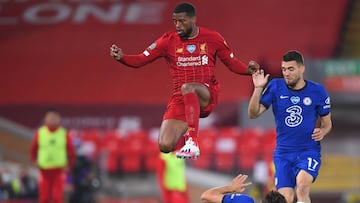 Liverpool's Dutch midfielder Georginio Wijnaldum (C) jumps a challenge from Chelsea's Spanish defender Marcos Alonso during the English Premier League football match between Liverpool and Chelsea at Anfield in Liverpool, north west England on Ju