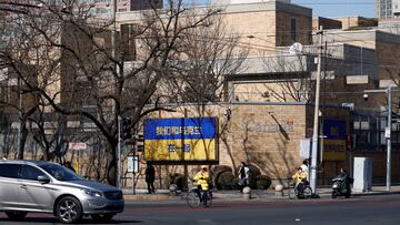 FILE PHOTO: People walk past billboards in support of Ukraine following Russia's invasion of the country, outside the Canadian embassy in Beijing, China March 2, 2022. The billboards read, "We are together with Ukraine" and "We support Ukraine". REUTERS/Carlos Garcia Rawlins/File Photo