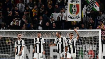 Juventus' Argentine forward Paulo Dybala (R) celebrates after scoring his third goal during the UEFA Champions League group H football match between Juventus and Young Boys on October 2, 2018 at the Juventus stadium in Turin. (Photo by Marco BERTOREL