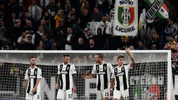 Juventus&#039; Argentine forward Paulo Dybala (R) celebrates after scoring his third goal during the UEFA Champions League group H football match between Juventus and Young Boys on October 2, 2018 at the Juventus stadium in Turin. (Photo by Marco BERTOREL