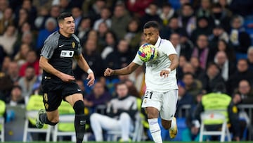 MADRID, SPAIN - FEBRUARY 15: Rodrygo Goes of Real Madrid controls the ball under pressure from Diego Gonzalez of Elche CF during the LaLiga Santander match between Real Madrid CF and Elche CF at Estadio Santiago Bernabeu on February 15, 2023 in Madrid, Spain. (Photo by Angel Martinez/Getty Images)