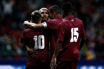 Venezuela's forward Josef Martinez (2ndL) celebrates with teammates after scoring his team's third goal during an international friendly football match between Argentina and Venezuela at the Wanda Metropolitano stadium in Madrid on March 22, 2019 in prepa