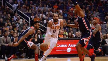 Nov 27, 2019; Phoenix, AZ, USA; Phoenix Suns guard Ricky Rubio (11) dribbles through Washington Wizards defenders during the first half at Talking Stick Resort Arena. Mandatory Credit: Joe Camporeale-USA TODAY Sports