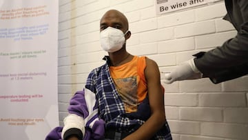 One of the first South African Oxford vaccine trialists looks on as a medical worker injects him with the clinical trial for a potential vaccine against the COVID-19 coronavirus at the Baragwanath hospital in Soweto, South Africa, on June 24 ,2020. (Photo