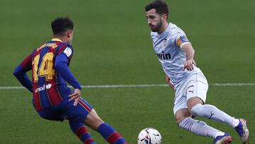 BARCELONA, SPAIN - DECEMBER 19:  Jose Gaya of Valencia CF takes on Philippe Coutinho of FC Barcelona during the La Liga Santander match between FC Barcelona and Valencia CF at Camp Nou on December 19, 2020 in Barcelona, Spain.Sporting stadiums around Spai