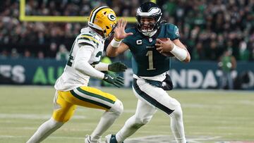 PHILADELPHIA, PENNSYLVANIA - JANUARY 12: Jalen Hurts #1 of the Philadelphia Eagles runs against Carrington Valentine #24 of the Green Bay Packers in the fourth quarter during the NFC Wild Card Playoff at Lincoln Financial Field on January 12, 2025 in Philadelphia, Pennsylvania. Al Bello/Getty Images/AFP (Photo by AL BELLO / GETTY IMAGES NORTH AMERICA / Getty Images via AFP)