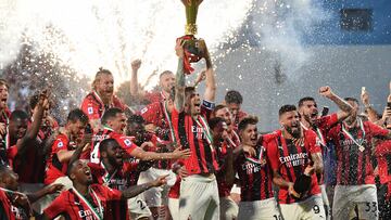 (FILES) In this file photo taken on May 22, 2022 AC Milan's Italian defender Alessio Romagnoli (C) and AC Milan's players celebrate with the winner's trophy after AC Milan won the Italian Serie A football match between Sassuolo and AC Milan, securing the "Scudetto" championship on May 22, 2022 at the Mapei - Citta del Tricolore stadium in Sassuolo. -