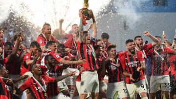 (FILES) In this file photo taken on May 22, 2022 AC Milan's Italian defender Alessio Romagnoli (C) and AC Milan's players celebrate with the winner's trophy after AC Milan won the Italian Serie A football match between Sassuolo and AC Milan, securing the "Scudetto" championship on May 22, 2022 at the Mapei - Citta del Tricolore stadium in Sassuolo. -