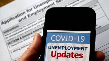 (FILES) In this file photo illustration, a COVID-19 Unemployment Assistance Updates logo is displayed on a smartphone on top of an application for unemployment benefits on May 8, 2020, in Arlington, Virginia. - The US economic recovery may be slower than 