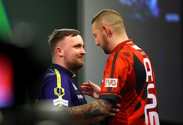 Luke Littler shakes hands with Nathan Aspinall after their quarter final match