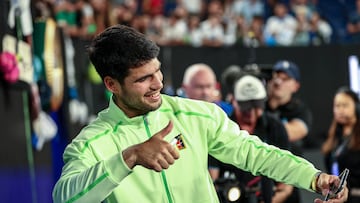 Spain's Carlos Alcaraz takes a selfie with fans after defeating Australia's Alex De Minaur in their men's singles quarter-final match on day ten of the Australian Open tennis tournament in Melbourne on January 27, 2026. (Photo by IZHAR KHAN / AFP) / -- IMAGE RESTRICTED TO EDITORIAL USE - STRICTLY NO COMMERCIAL USE --