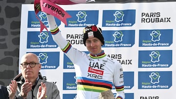 Second placed UAE Team Emirate's Slovenian rider Tadej Pogacar (c) celebrates on the podium of the 122nd edition of the Paris-Roubaix one-day classic cycling race, 259,2 km between Compiegne and Roubaix, northern France on April 13, 2025. (Photo by Jeff PACHOUD / AFP)