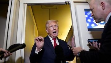 U.S. President Donald Trump speaks to members of the media onboard Air Force One, on a flight to Joint Base Andrews in Maryland, U.S. April 13, 2025. REUTERS/Nathan Howard TPX IMAGES OF THE DAY