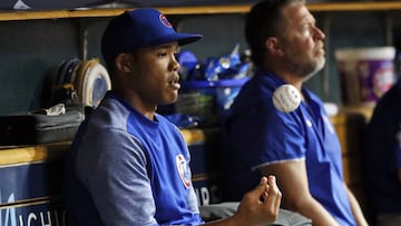 FILE - In this Aug. 21, 2018, file photo, Chicago Cubs&#039; Addison Russell flips a baseball in the dugout in the sixth inning of a baseball game against the Detroit Tigers in Detroit, Russell was placed on administrative leave Friday, Sept. 21, 2018, following fresh allegations of domestic violence by his ex-wife.
 (AP Photo/Paul Sancya, File)