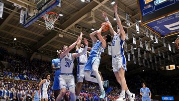 DURHAM, NORTH CAROLINA - MARCH 09: Kyle Filipowski #30, Jared McCain #0 and TJ Power #12 of the Duke Blue Devils defend a drive by Cormac Ryan #3 of the North Carolina Tar Heels during the first half of the game at Cameron Indoor Stadium on March 09, 2024 in Durham, North Carolina.   Grant Halverson/Getty Images/AFP (Photo by GRANT HALVERSON / GETTY IMAGES NORTH AMERICA / Getty Images via AFP)