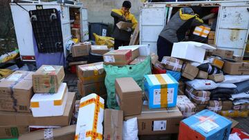 Delivery workers sort parcels at a makeshift logistics station near the Central Business District (CBD) during Singles&rsquo; Day shopping festival in Beijing, China November 11, 2021. 