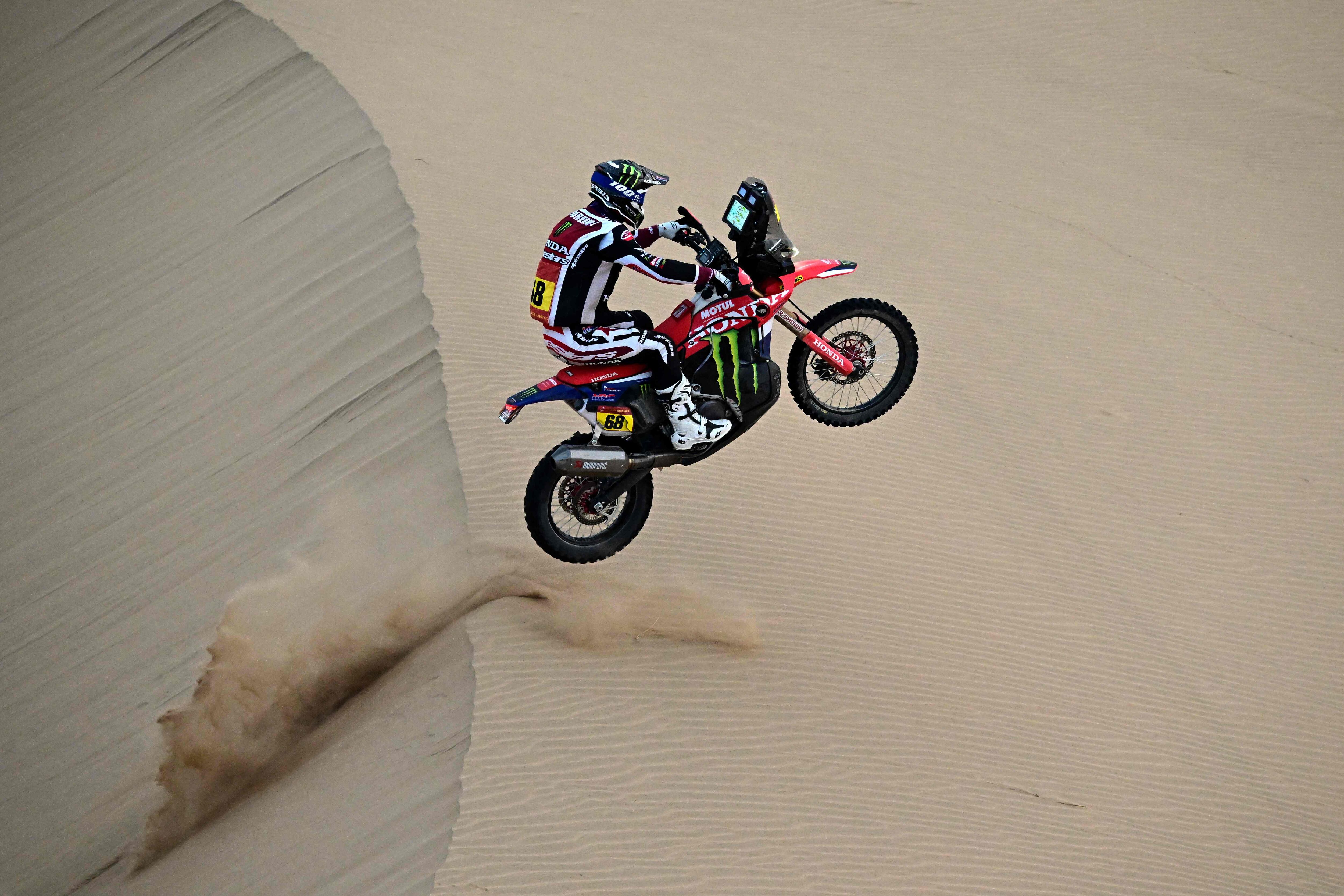 Spanish rider Tosha Schareina competes with a Honda Crf 450 compete in Stage 10 of the 48th edition of the Dakar Rally 2026, between Bisha and Bisha, Saudi Arabia, on January 14, 2026. (Photo by Giuseppe CACACE / AFP)