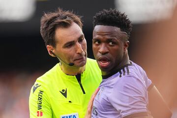 Vinicius with the referee as the Mestalla crowd hurling racist insults at him, and threatening to leave the field of play. Later, there was a major brawl between Valencia and Real Madrid players, resulting in Vinicius being sent off.