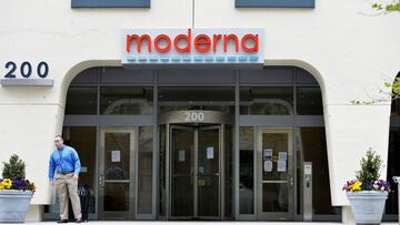 A man stands outside Moderna headquarters in Cambridge, Massachusetts on May 18, 2020. - US biotech firm Moderna reported promising early results from the first clinical tests of an experimental vaccine against the novel coronavirus performed on a small number of volunteers. The Cambridge, Massachusetts-based company said the vaccine candidate, mRNA-1273, appeared to produce an immune response in eight people who received it similar to that seen in people convalescing from the virus. (Photo by Joseph Prezioso / AFP)
