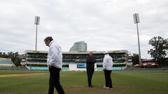 Umpires and ground staff inspect the playing surface in Durban. 