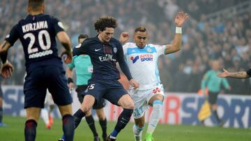 Paris Saint-Germain's French midfielder Adrien Rabiot (C) vies with Olympique de Marseille's French forward Dimitri Payet (R) during the French L1 football match Marseille vs Paris on February 26, 2017, at the Velodrome stadium in Marseille, southern France