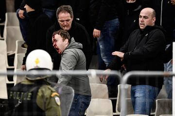 AEK Athens fans jumped onto the pitch and launched flares at the Ajax fans in the Champions League game in Greece on Tuesday night, causing police to intervene.
