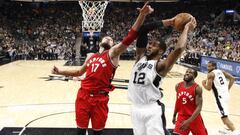 Jan 3, 2017; San Antonio, TX, USA; San Antonio Spurs forward LaMarcus Aldridge (12) grabs a rebound as Toronto Raptors center Jonas Valanciunas (17) defends during the second half at AT&amp;T Center. The Spurs won 110-82. Mandatory Credit: Soobum Im-USA TODAY Sports