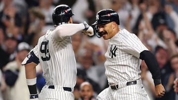 NEW YORK, NEW YORK - OCTOBER 07: Aaron Judge #99 of the New York Yankees reacts with Trent Grisham #12 after a three-run home run against the Toronto Blue Jays during the fourth inning in game three of the American League Division Series at Yankee Stadium on October 07, 2025 in the Bronx borough of New York City. Ishika Samant/Getty Images/AFP (Photo by Ishika Samant / GETTY IMAGES NORTH AMERICA / Getty Images via AFP)
