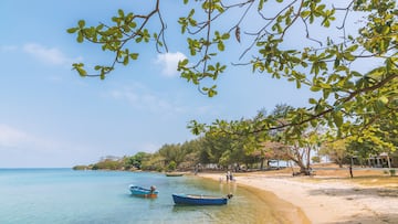 Seaside beach view with fisher boat see through the water to sebase